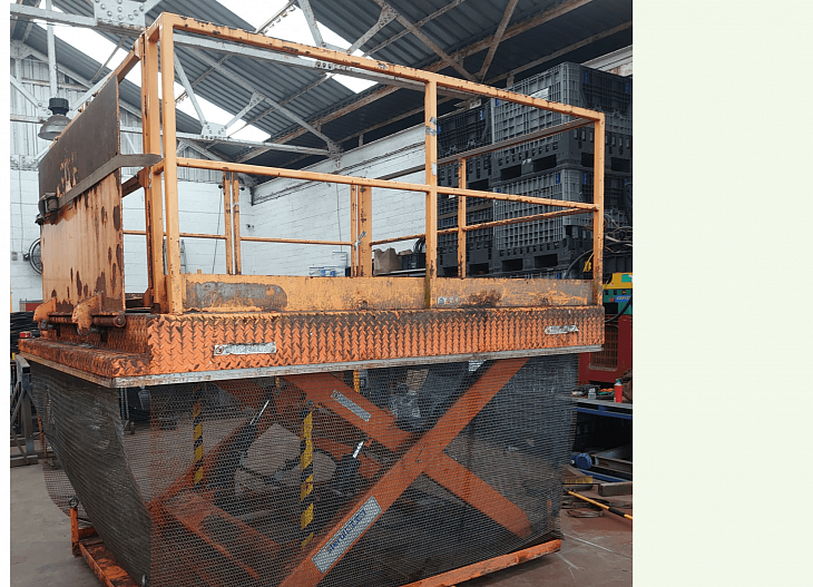 Orange scissor lift refurbishment before